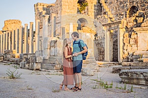 Loving couple of tourists at the ruins of ancient city of Perge near Antalya Turkey. Traveling with kids concept photo