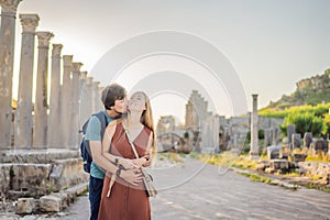 Loving couple of tourists at the ruins of ancient city of Perge near Antalya Turkey. Traveling with kids concept photo