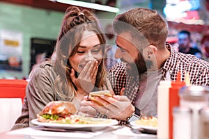 Loving couple using mobile phone