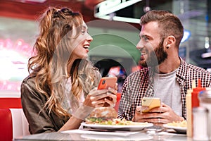 Loving couple using mobile phone