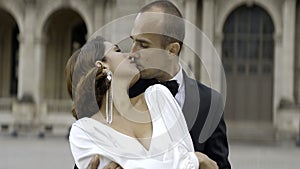 Loving couple video shooting on their wedding day. Action. Bride in white dress and groom in suit on the background of