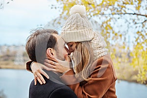 Loving couple walking in Park in autumn hugs and kisses. Autumn