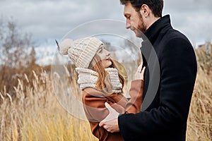 Loving couple walking in Park in autumn hugs and kisses. Autumn