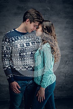 Loving couple in winter warm pullovers.