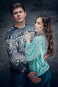 Loving couple in winter warm pullovers.