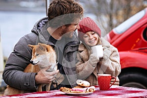 Loving dad on winter holidays has picnic outdoor with little daughter and dog on Christmas vacation