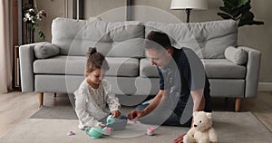 Loving daddy play with little charming cute daughter at home