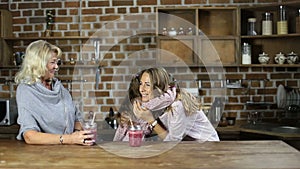 Loving daughter embracing mother in the kitchen