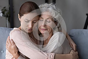 Loving daughter hug and comfort old upset mom