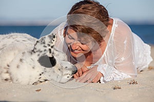 Loving dog owner at beach