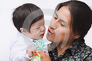 Loving ecuadorian father kissing his baby photo