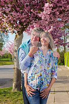 Loving elderly couple enjoying the spring sunshine.