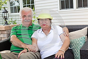 Loving elderly couple relaxing on an outdoor patio
