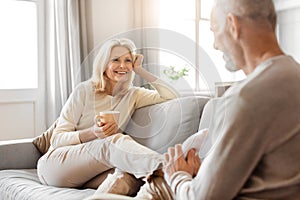 Loving elderly husband massaging his wife legs