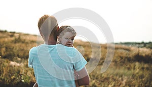 Loving family. Father and his son baby boy playing and hugging outdoors. Happy dad and son outdoors. Concept of Father`s day.