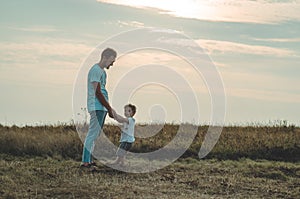 Loving family. Father and his son baby boy playing and hugging outdoors. Happy dad and son outdoors. Concept of Father`s day.