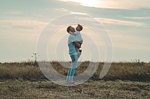 Loving family. Father and his son baby boy playing and hugging outdoors. Happy dad and son outdoors. Concept of Father`s day.