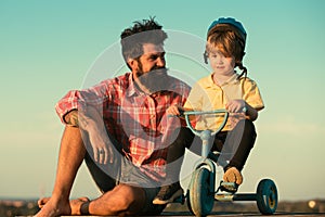 Loving family Father and son. Dad help his child ride a bicycle.