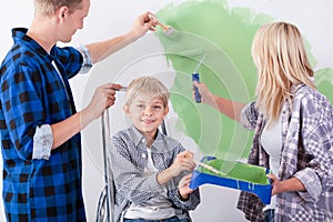 Loving family painting wall together