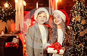 Loving family. small girl and boy in christmas shop. happy children exchange presents at xmas. best greetings and wishes