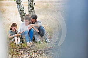 Photo of Loving family together in a park, field or woodlands