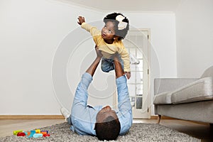 Loving father african american man having fun with his daughter