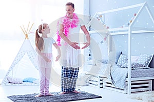 Loving father dressed in costume playing with daughter