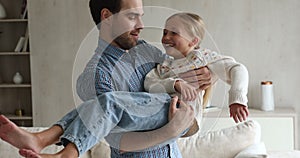 Loving father sing dance holding laughing little girl on hands