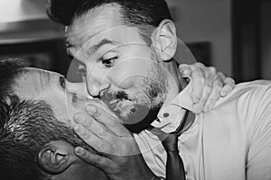 Loving gay couple kissing passionately at the wedding party - Two handsome men having romantic kiss indoors - LGBT wedding and