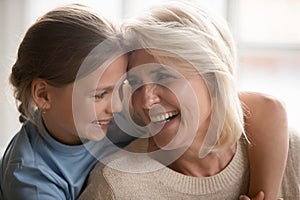 Loving granddaughter hug happy grandmother enjoying time together
