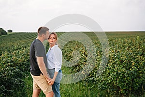 Loving guy and girl walking in nature.concept of love story outdoor.Lovers Walking in spring park.stylish couple in love hugging