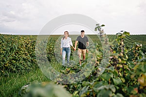 Loving guy and girl walking in nature.concept of love story outdoor.Lovers Walking in spring park.stylish couple in love hugging