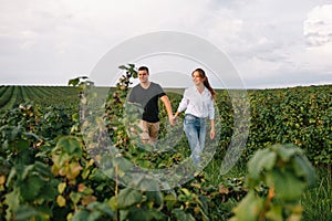 Loving guy and girl walking in nature.concept of love story outdoor.Lovers Walking in spring park.stylish couple in love hugging