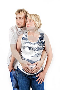 Loving happy couple, pregnant woman with her husband, isolated on white