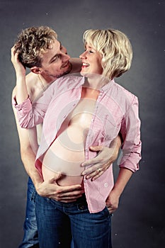 Loving happy couple, smiling pregnant woman with her husband