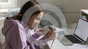 Loving teen girl play with domesticated mouse photo