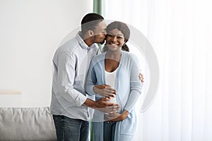 Loving husband kissing his pretty pregnant wife