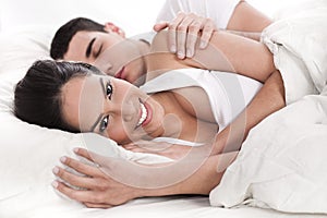 Loving husband and wife lying in bed