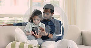 Loving Indian dad teach little son to use modern smartphone