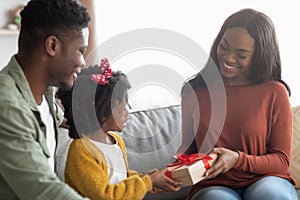 Loving Little Daughter Greeting Black Young Woman With Mother& x27;s Day At Home