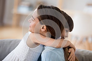 Loving little girl hug mom showing empathy and care