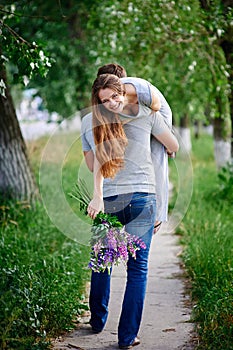 Loving man holding woman on his shoulder