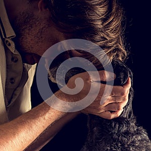 Loving man hugging his terrier dog