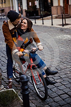 Loving man riding his girlfriend on his bike stock photo