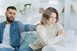 Loving man soothing upset woman, apologizing after quarrel