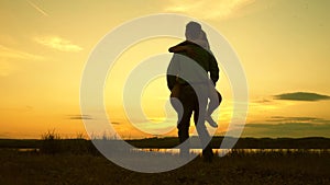 Loving man and woman dance in bright rays of sun on the background of the lake. couple dancing at sunset on beach. Happy