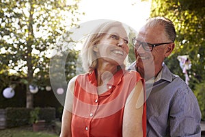 Loving Mature Couple In Back Yard Garden