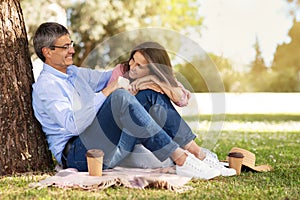 Loving Mature Couple Relaxing Together Outdoors In Summer Park