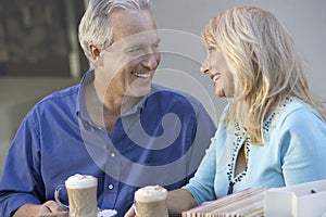 Loving Middle Aged Couple Sitting At CafÃ©