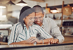 Loving mixed race couple laughing and enjoying time together on first date. Young woman and man on a coffee date in a